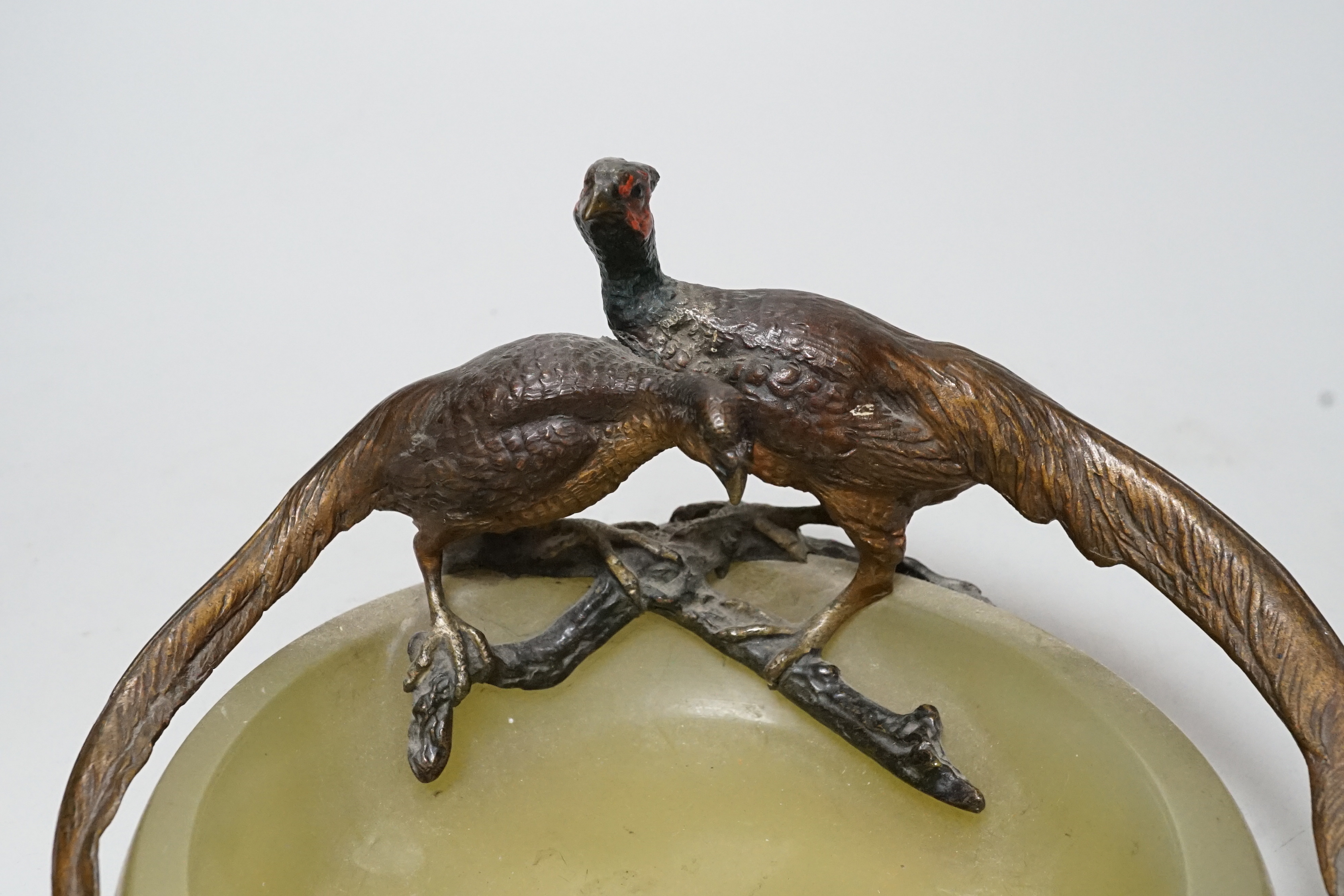 A cold painted bronze ‘pheasant’ mounted onyx ashtray, 17cm wide